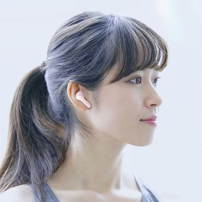 Woman with gray hair tied back against a light background