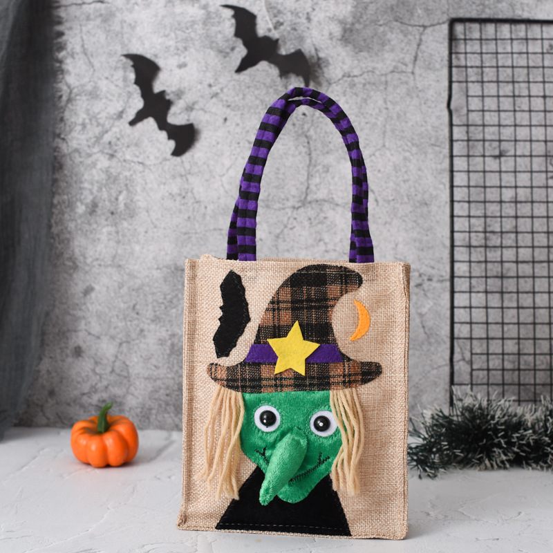 Halloween-themed jute bag with witch design and pumpkin on a gray background