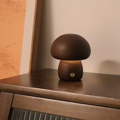 Mushroom-shaped lamp on a wooden surface with a warm glow