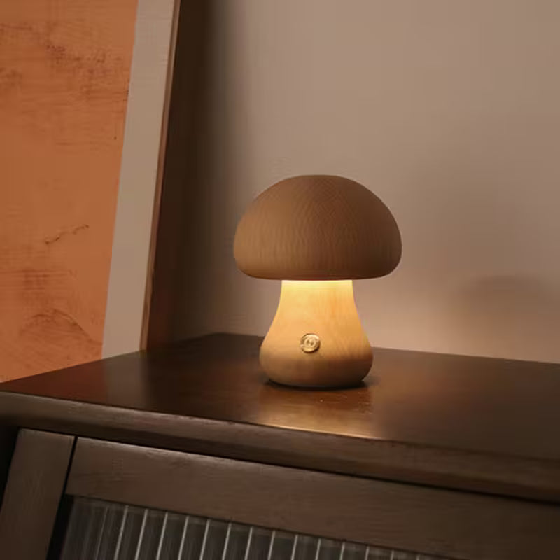 Wooden mushroom-shaped lamp on a wooden surface with a warm glow.