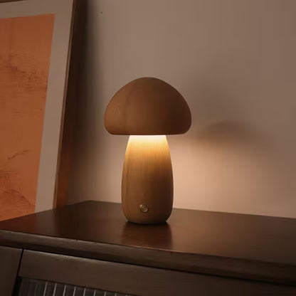 Wooden mushroom-shaped lamp on a surface with a warm glow