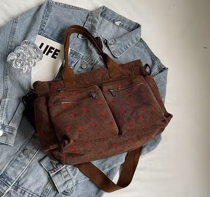 Brown corduroy bag with red patterns on a denim jacket