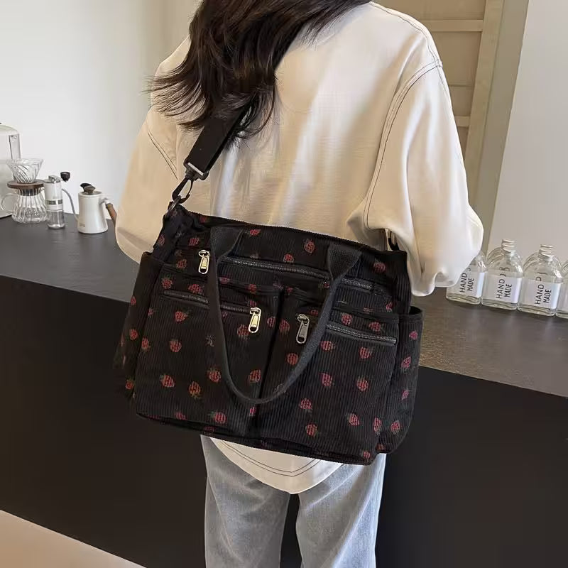 Person holding a black patterned handbag in a kitchen setting