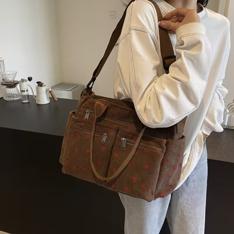 Person holding a brown patterned bag in a casual setting