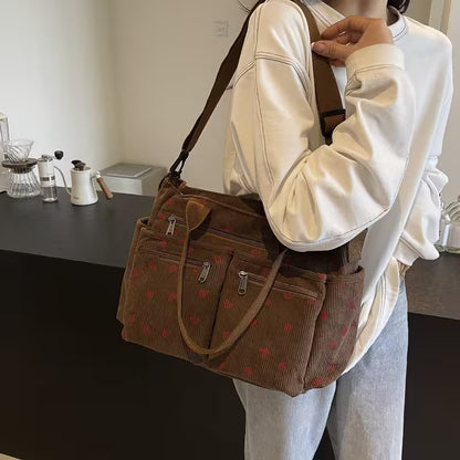 Person holding a brown patterned bag in a casual setting