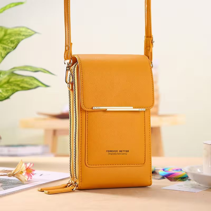 Yellow crossbody bag on a table with a blurred background