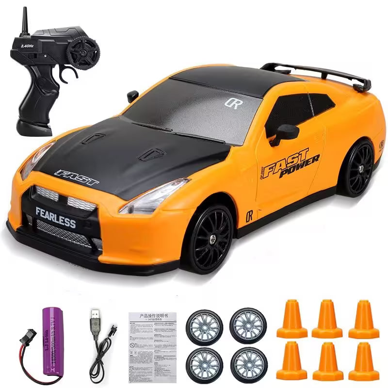Orange toy car with black details and remote control on a white background