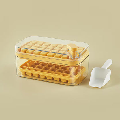 Yellow ice cube tray with clear lid and white scoop on a beige background