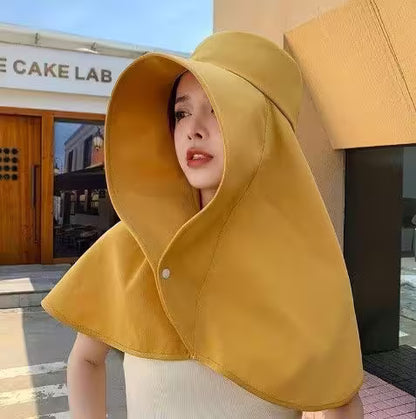 Person wearing a yellow hooded garment in front of a building with 'CAKE LAB' sign.